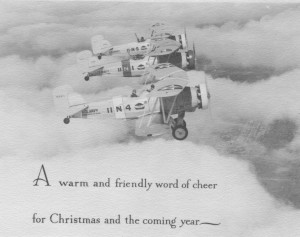 Three vintage biplanes flying in formation above clouds with the text: "A warm and friendly word of cheer for Christmas and the coming year.
